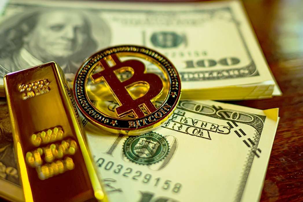 Bitcoin and gold bars on a table, showcasing the growing fascination with cryptocurrencies like Bitcoin in conjunction with traditional investments like gold bars.