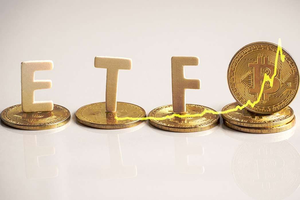 A stack of coins with the word ETF written on them, showcasing the involvement of crypto.