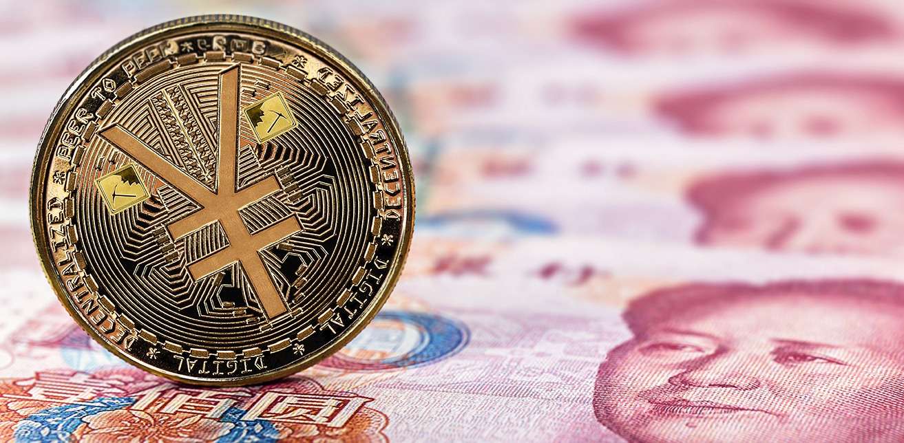 A yuan coin sits on top of Chinese currency, showcasing the intersection of traditional money and the evolving crypto landscape.