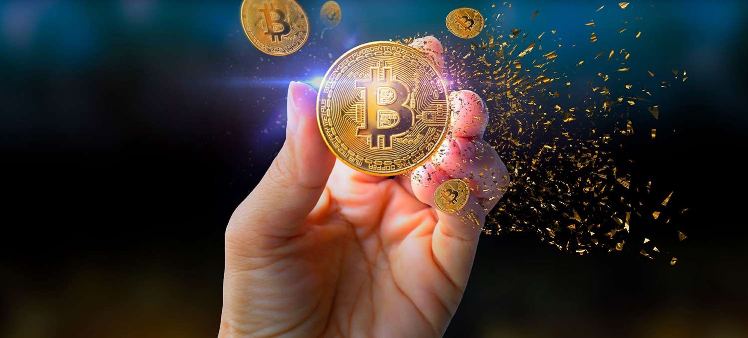 A person's hand holding a crypto coin.
