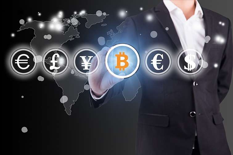 A businessman in a suit is holding a blockchain symbol in front of a world map.