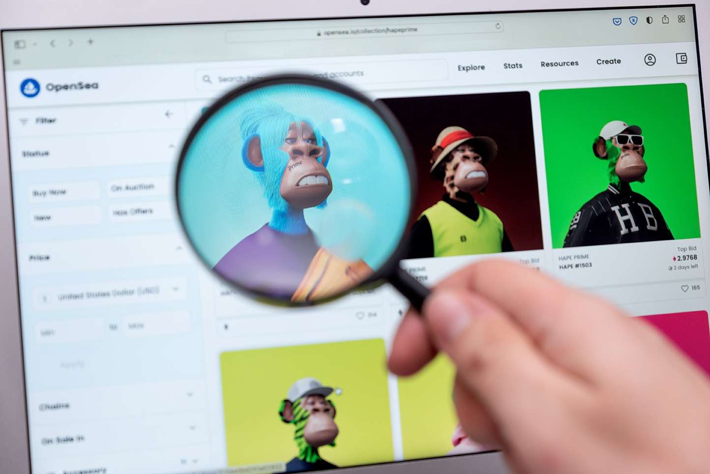 A person using a magnifying glass to analyse blockchain on a laptop screen.
