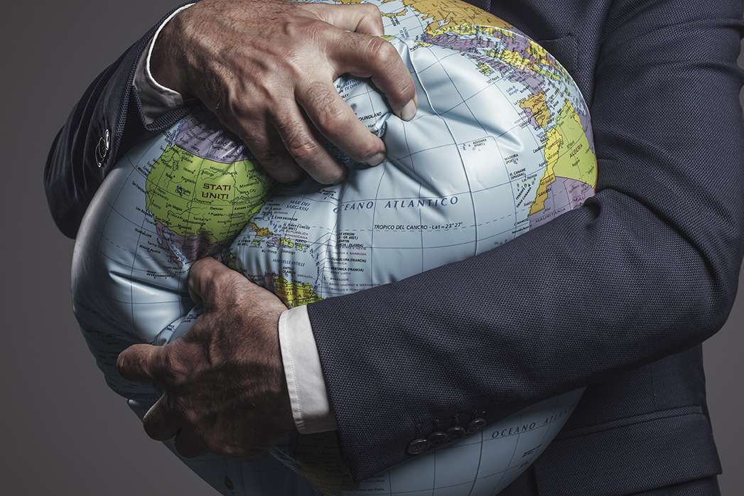 Greedy corporate businessman crushing and exploiting earth.