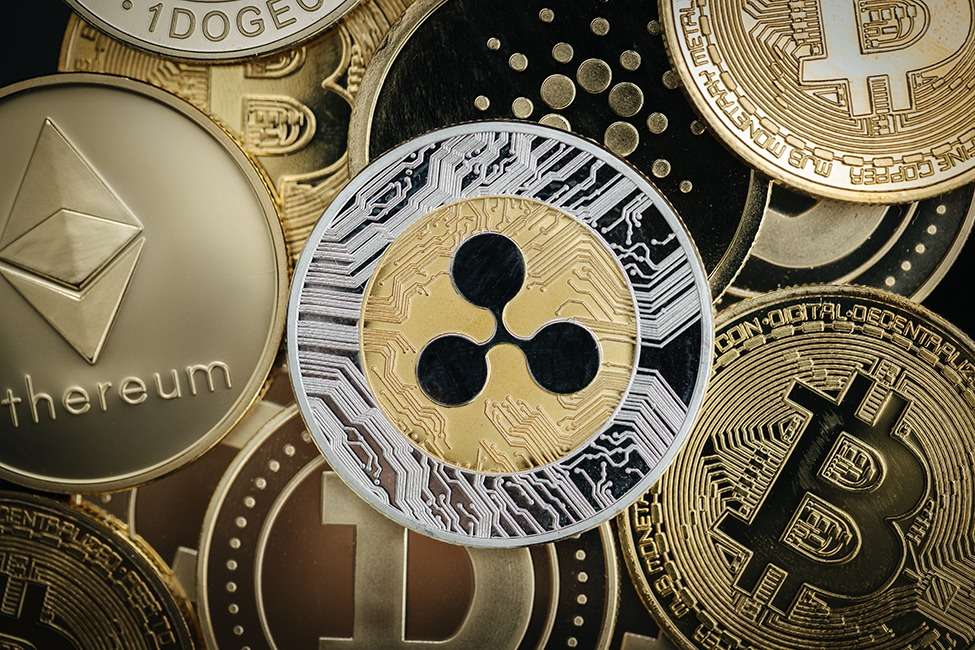A group of ripple coins XRP, a popular crypto, on a black background.
