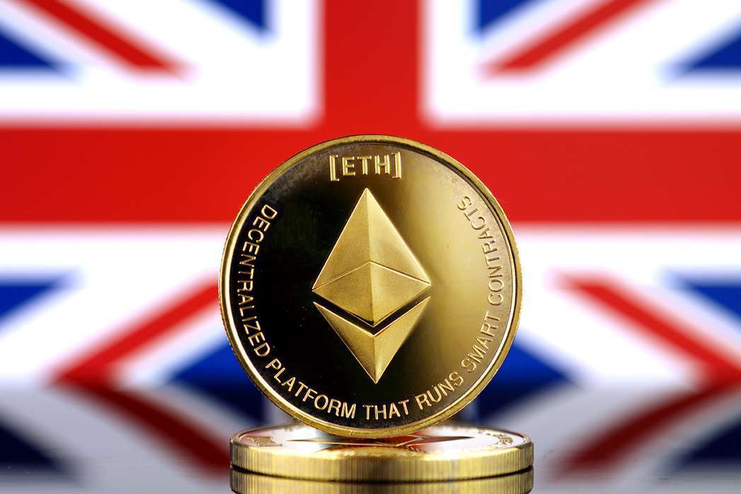 Physical version of Ethereum (ETH), new virtual money and United Kingdom Flag. Conceptual image for worldwide cryptocurrency and digital payment system. Studio shot.