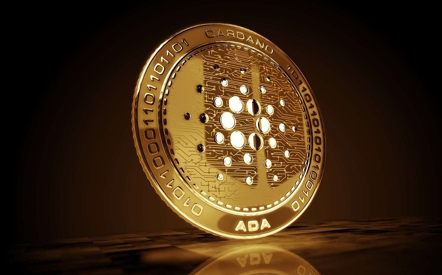 Gold Cardano (ADA) coin on a black background.