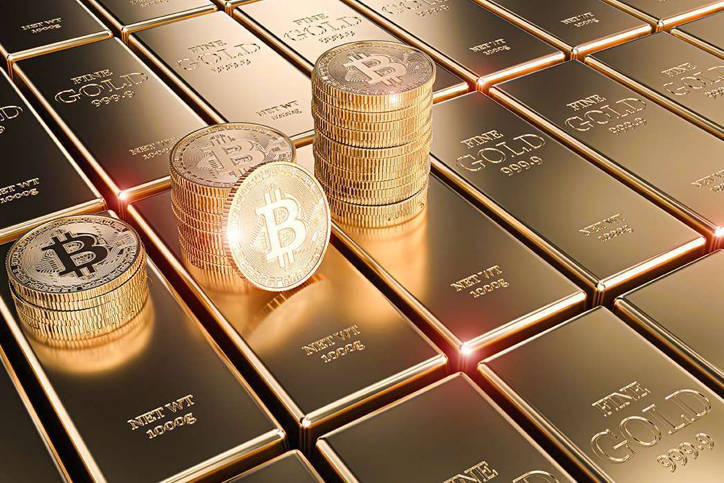 Bitcoin coins stacked on blocks of Gold bars as the background.