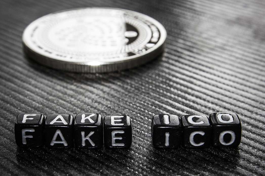 Words fake ico of black cubes and silver coin dark .