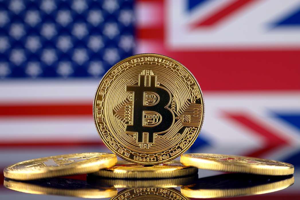 Physical version of Bitcoin (new virtual money), USA and UK Flag. Conceptual image for investors in cryptocurrency and Blockchain Technology in United States and United Kingdom.