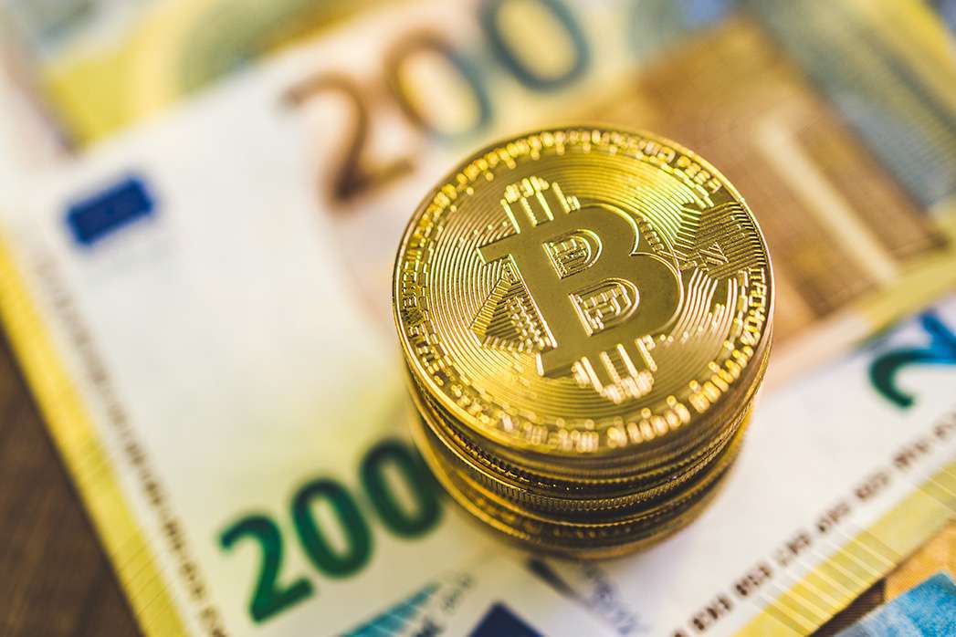 Cryptocurrency. Bitcoin virtual money. Golden coins and euro banknotes.