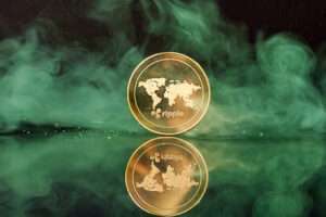 Standing golden ripple coin with smoke on reflective surface