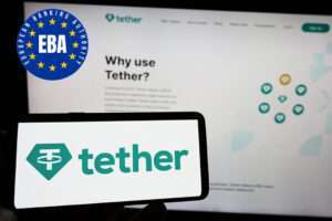 Stuttgart, Germany - 01-15-2023: Person holding smartphone with logo of crypto company Tether Operations Limited on screen in front of website. Focus on phone display.