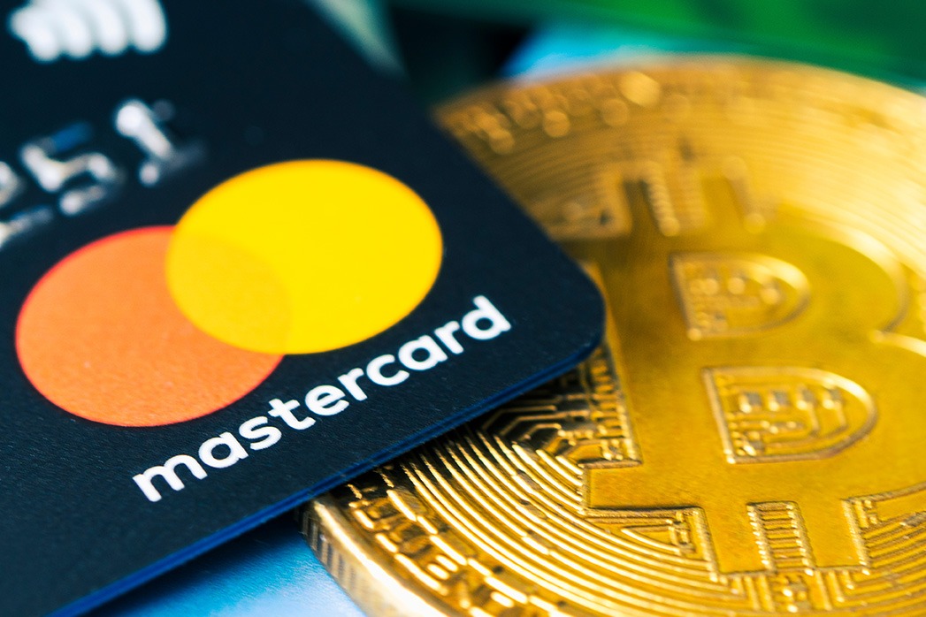 Gold bitcoin symbol and credit card master cards on the table.