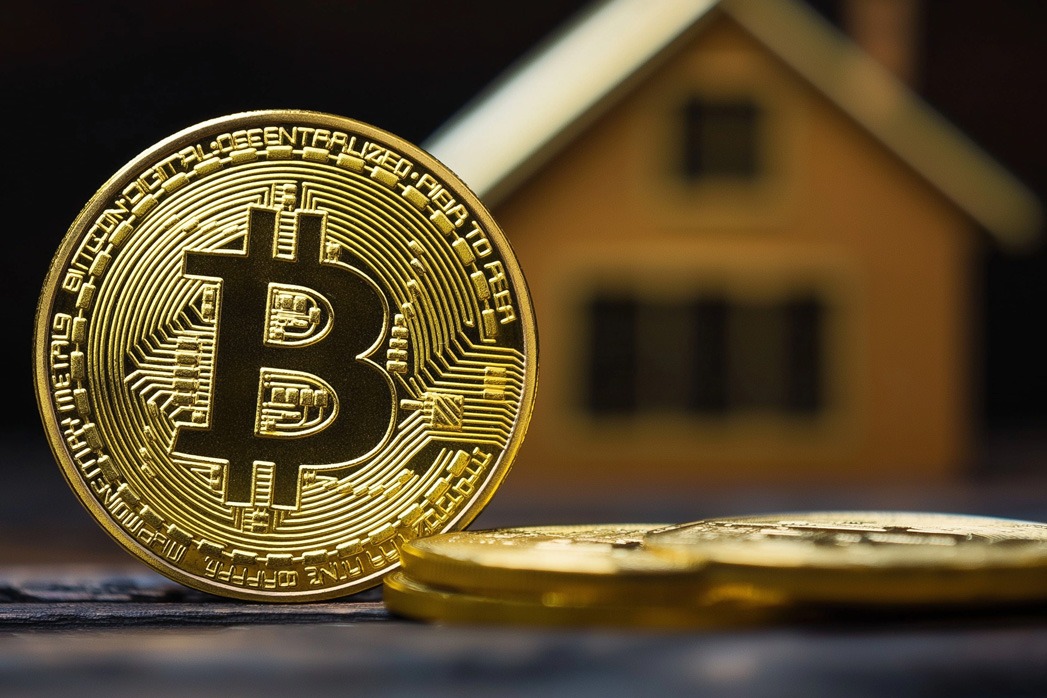 Golden bitcoin coin with house silhouette. Suitable for real estate cryptocurrency, digital property investment, and blockchain housing.