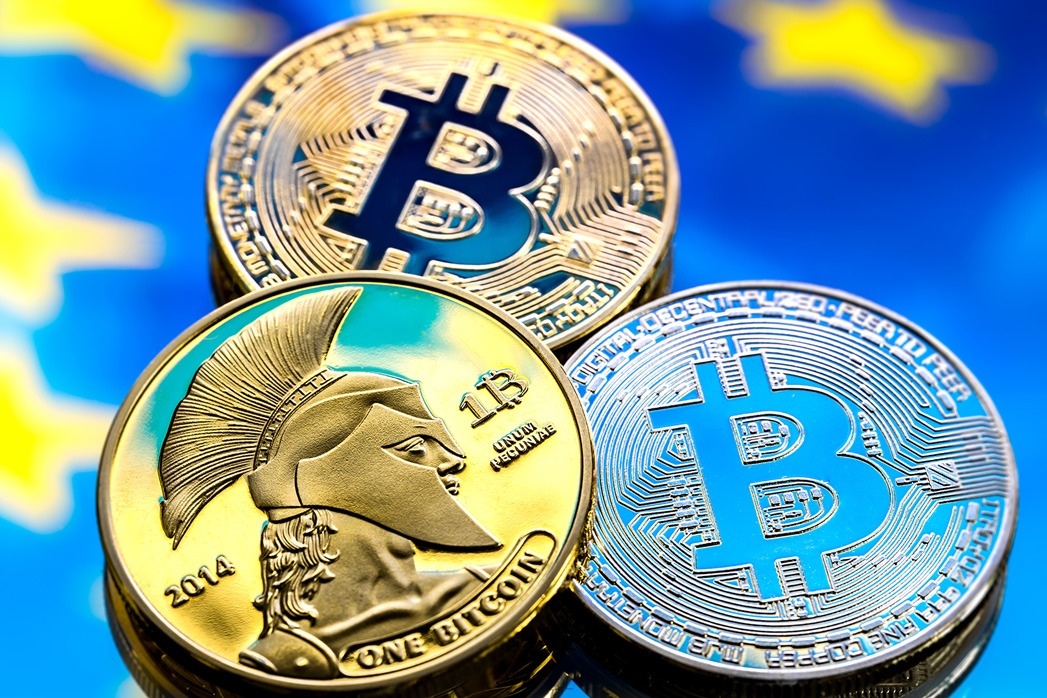 Coins Bitcoin, against the backdrop of Europe and the European flag.