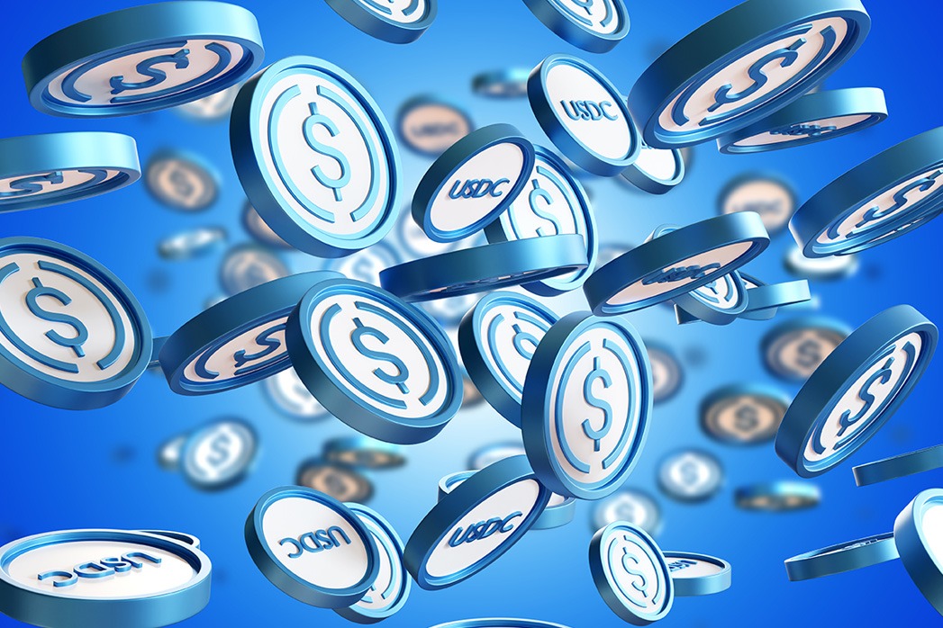 USDC technology. USDC logo on coins. Cryptocurrency exchange concept. Making payments using USDC technology. Buying cryptocurrency for fiat dollars. Blue background with Stablecoins. 3d rendering.