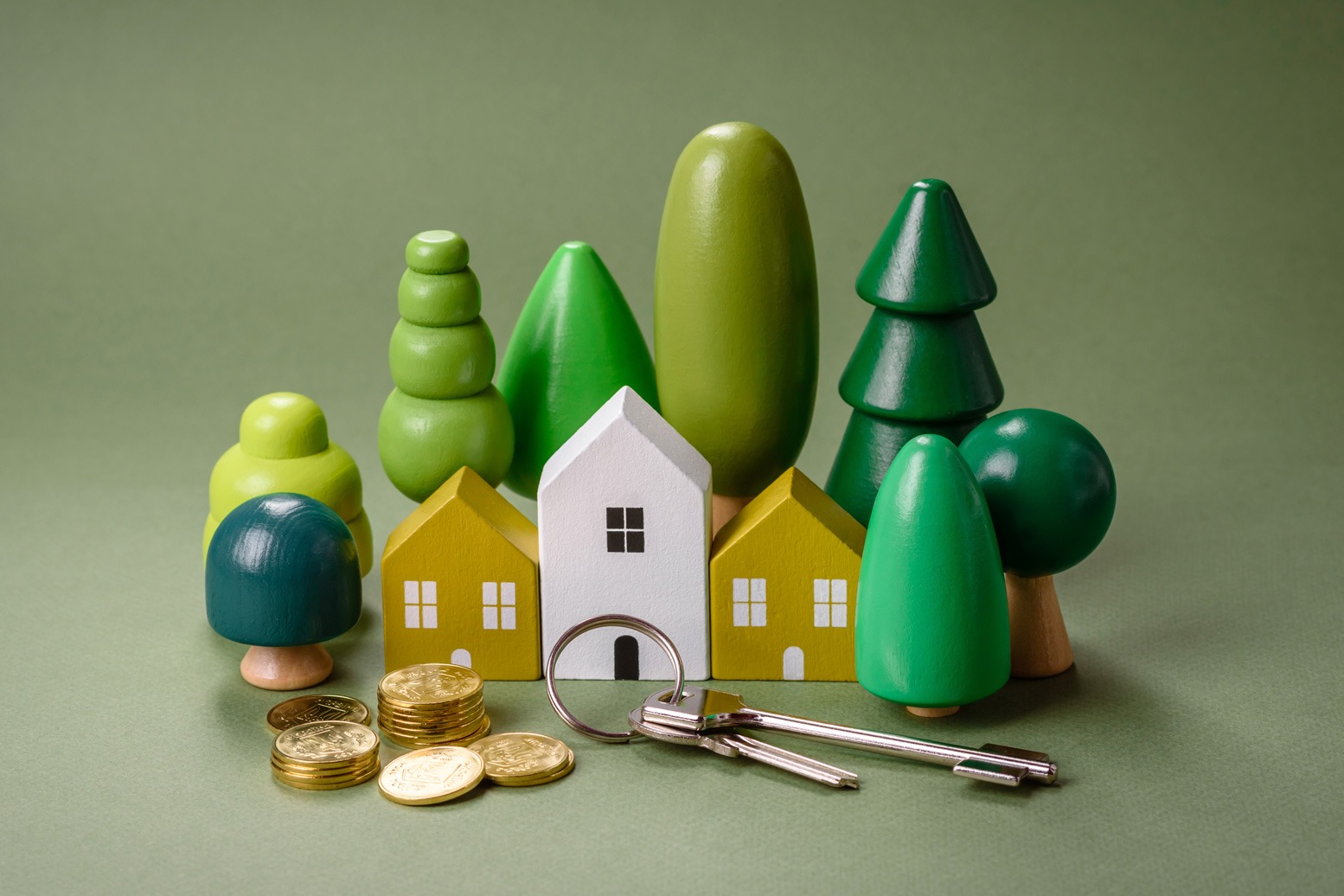 A small wooden house, money and keys as an idea for investing in your own home.