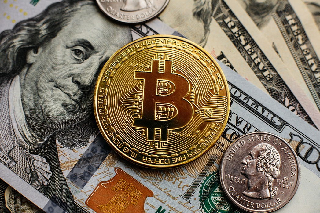 Bitcoin, Currency, digital, finance, economy. Golden bitcoin coin on us dollars close up.