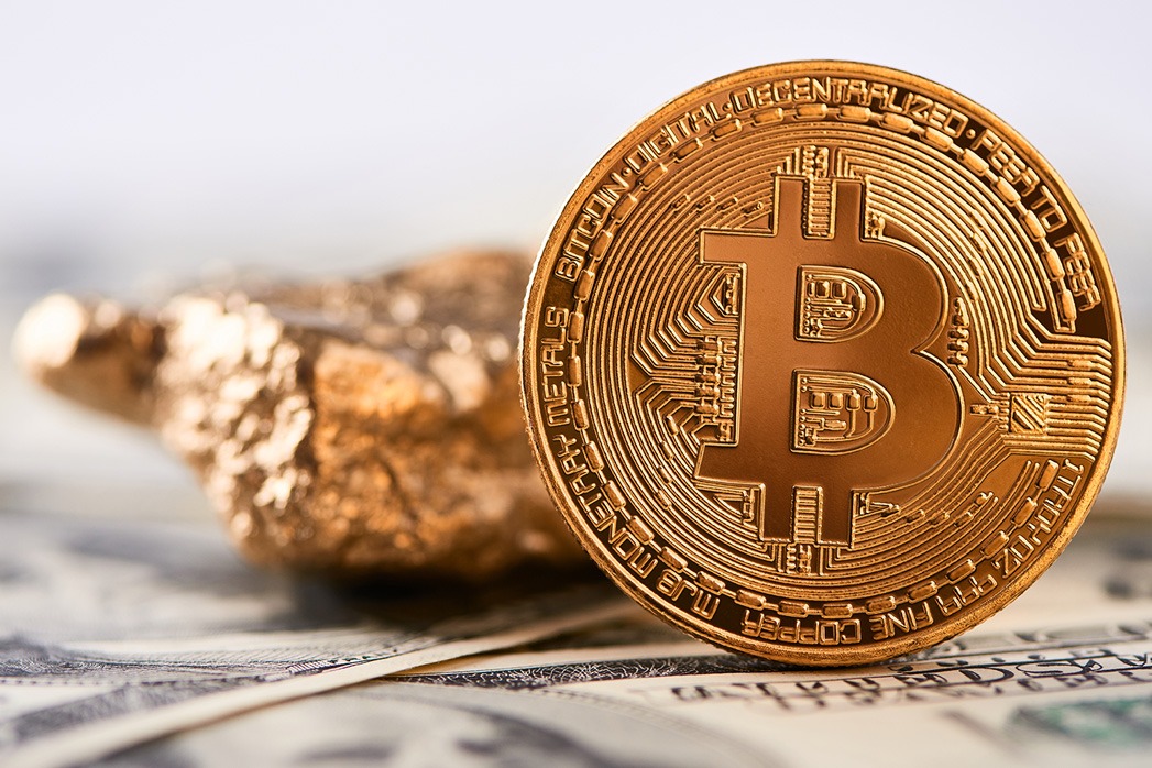 Shiny golden bitcoin and gold lump put on dollar banknote and represent new financial trends.
