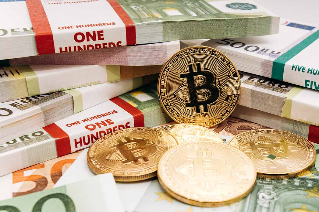 Crypto currency concept - a bitcoin with euro bills.