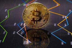 Closeup Of Gold Bitcoin Over Value Graph.