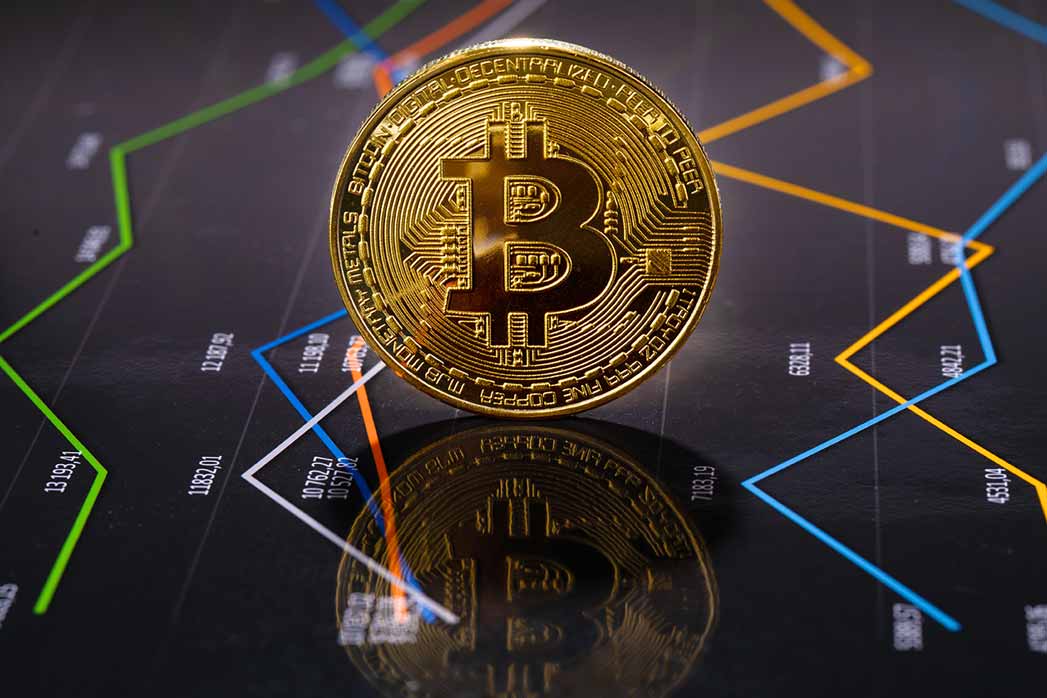 Closeup Of Gold Bitcoin Over Value Graph.