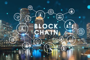 City view panorama of Boston Harbour and Seaport Blvd at night time, Massachusetts. Decentralized economy. Building exteriors of financial downtown.