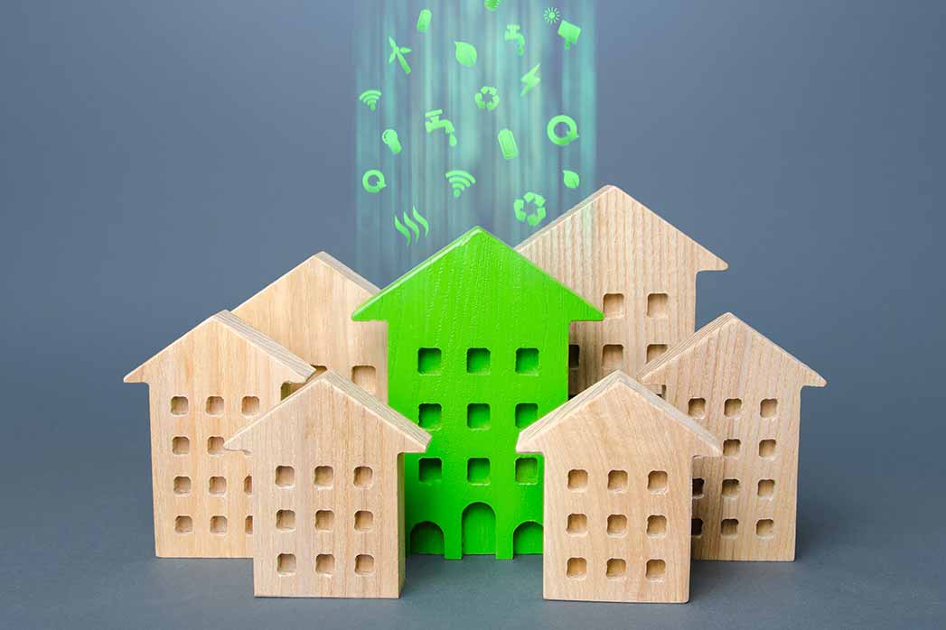 The green building stands out among the houses.