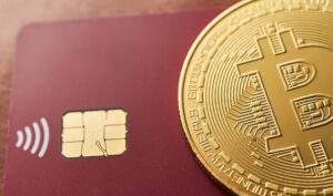 One bitcoin on a bank credit card, the new economy, Virtual cryptocurrency concept.