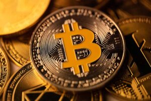 Top view macro closeup of crypto bitcoin silver coin on top of other cryptocurrency coins