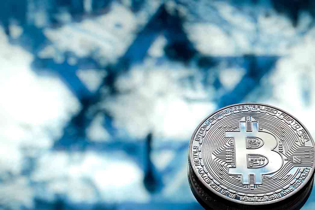 Bitcoin coins on the background of the Israeli flag, the concept of virtual money, close-up.
