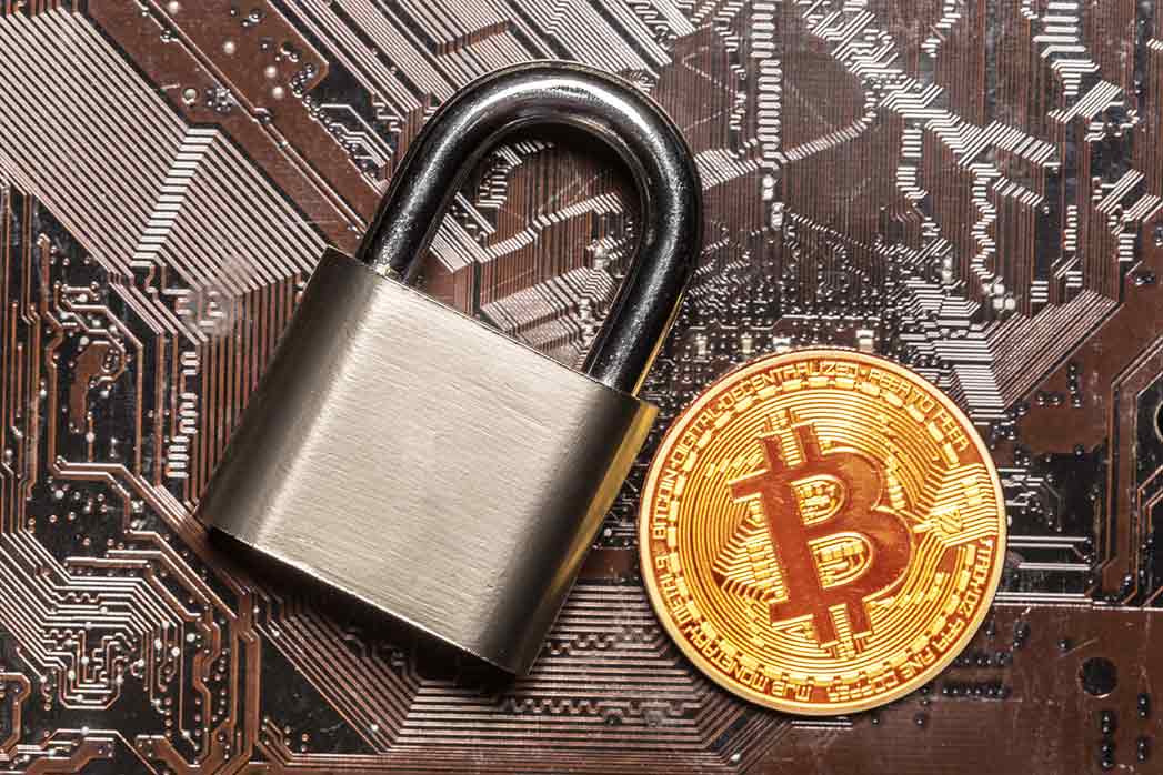 Bitcoin Coin, padlock and computer board.