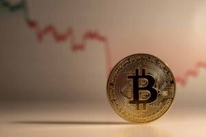 Golden coin with bitcoin symbol.