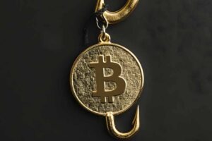 Close-up of a gold Bitcoin coin caught on a fishing hook, highlighting investment risk and cryptocurrency security threats.