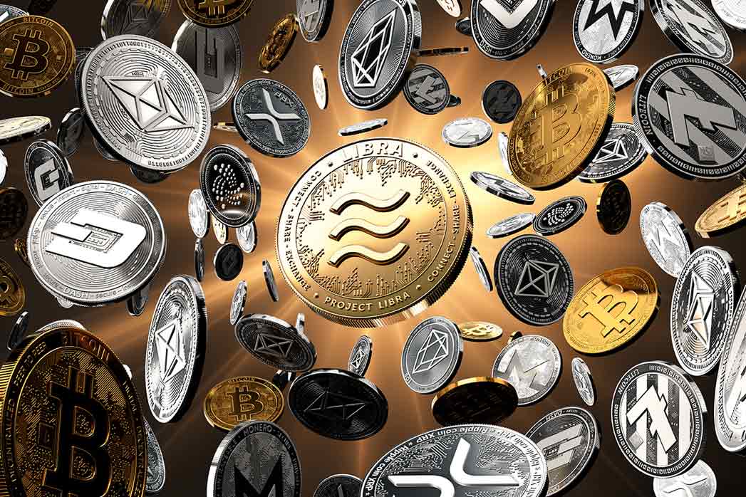 Flying altcoins with the Libra concept coin in the centre, probably the new most popular cryptocurrency. Golden starburst background - 3D rendering.