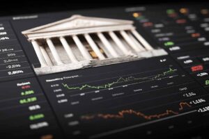 A financial interface displaying institutional architecture blended with market charts, symbolising economic activity, policy impact and global financial behaviour.