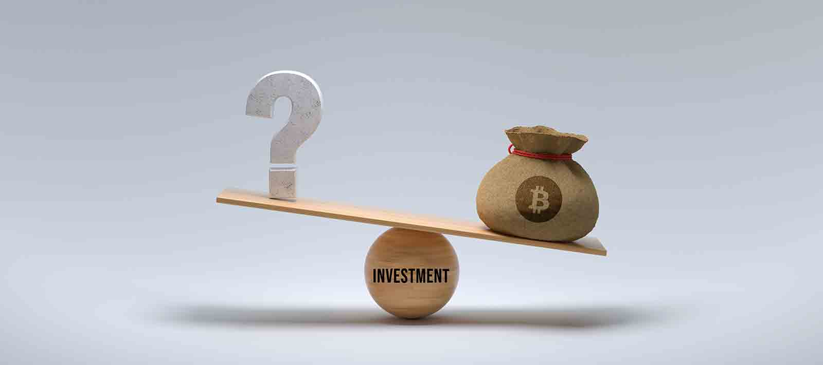 Wooden scale balancing bitcoin and a question mark on white background.