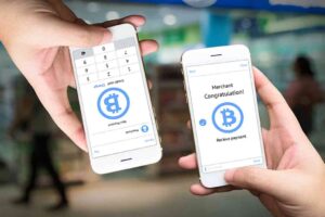 Peer-to-peer (P2P) money transfer, electronic payment, Mobile payment, and e-commerce concept. Hands holding a mobile application for sending and receiving money with a retail store background.
