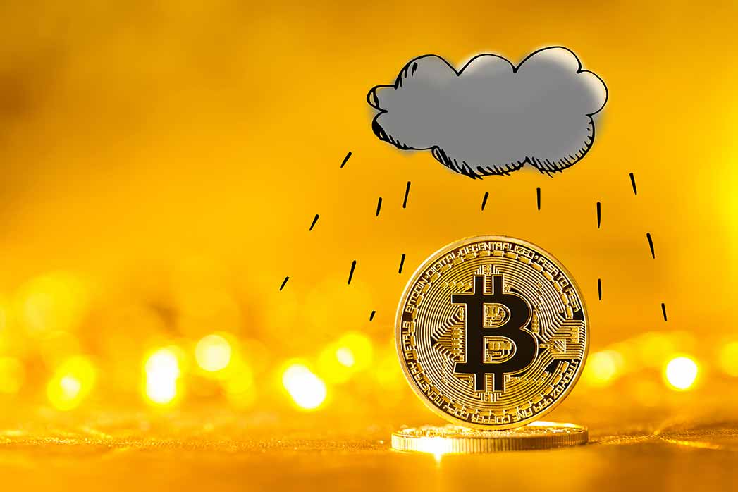 Rain cloud with gold bitcoin cryptocurrency coin.