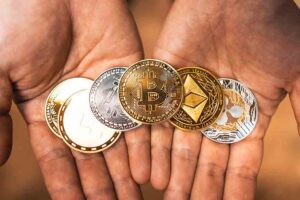Selection of Cryptocurrency Coins Held in Open Hands.