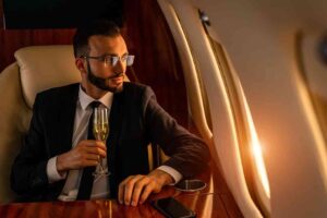 Businessman in a business suit flying on a luxury private jet, concepts of travel, transportation, and a wealthy lifestyle.