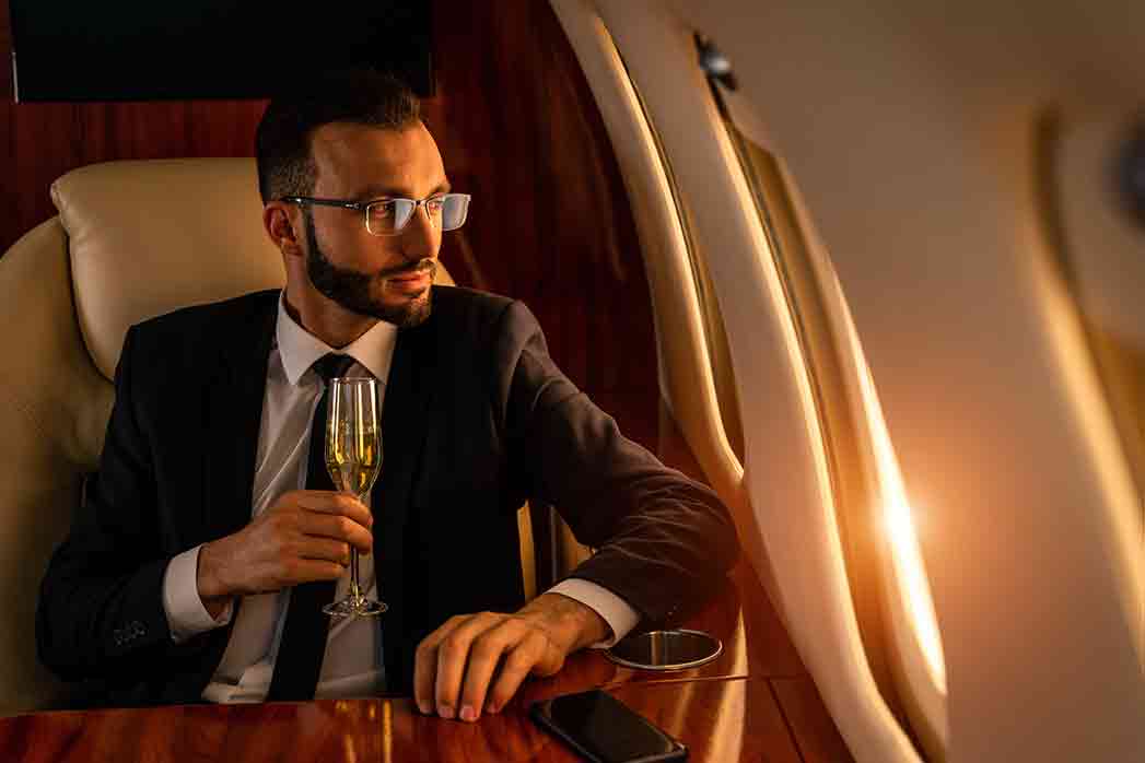Businessman in a business suit flying on a luxury private jet, concepts of travel, transportation, and a wealthy lifestyle.