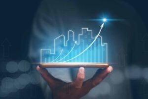 Concept of business prosperity and asset management, Real estate investment marketing analysis, Businessman holding mobile phone with graph of asset business growth, Planning to increase profits.