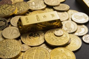 A gold bar on a pile of coins - business concept