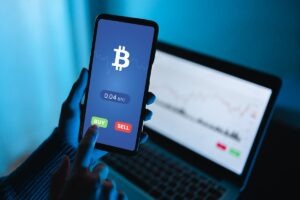 Trader using exchange crypto currency app using mobile phone - Stock market investor