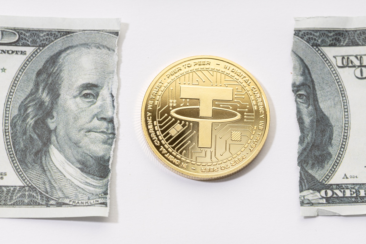 Tether USDT coin and ripped dollar bill. Broken USDT dollar parity concept